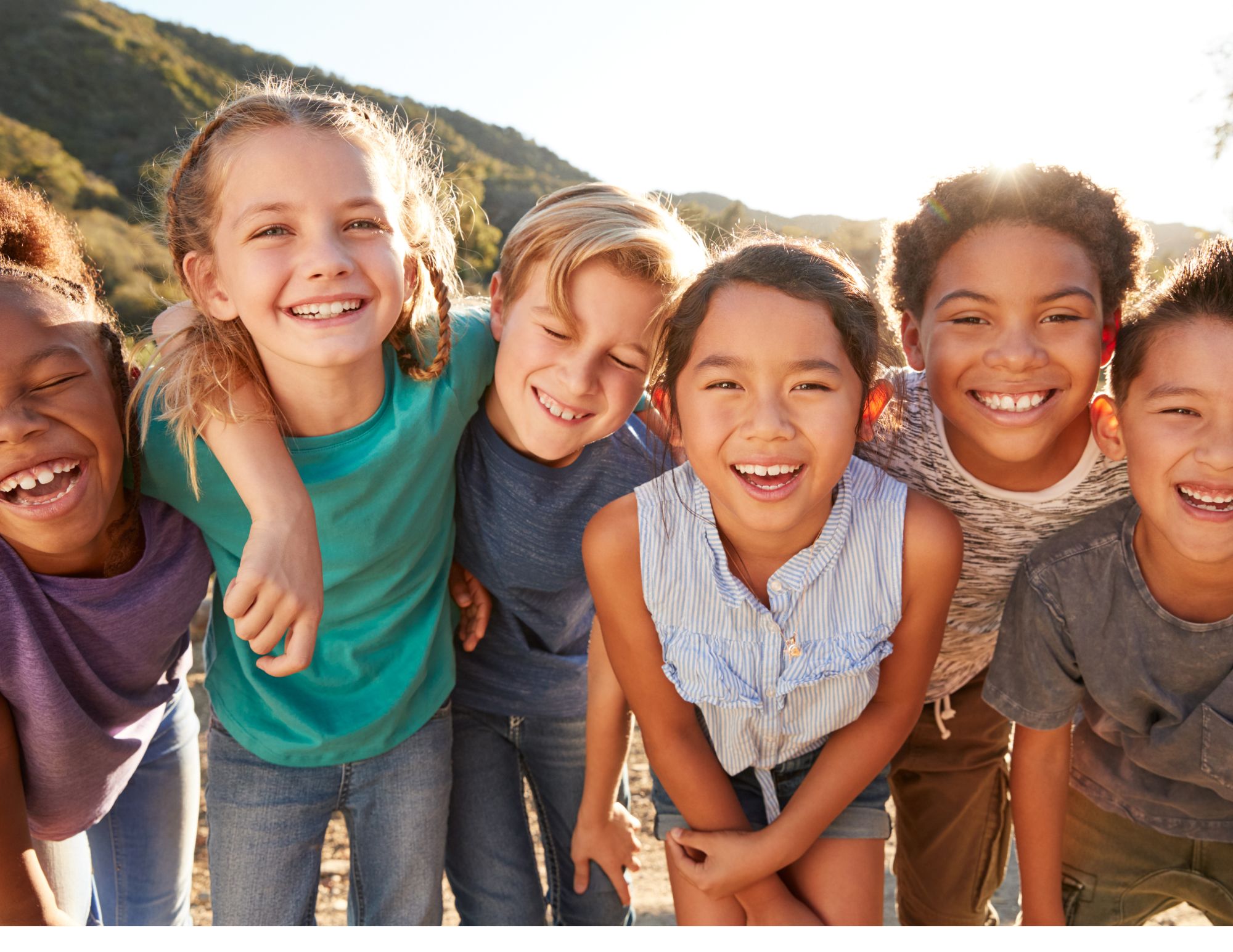 Children smiling and laughing together outdoors